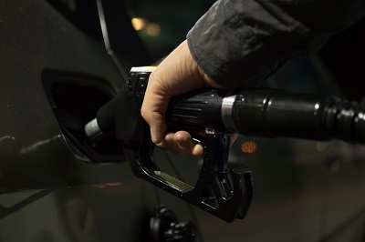 Close-up of a hand holding a fuel pump nozzle