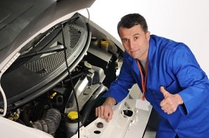 a mechanic repairing a vehicle a mechanic repairing a vehicle