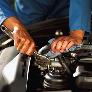 a mechanic repairing a vehicle a mechanic repairing a vehicle
