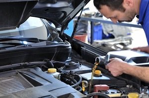 a mechanic changing oil a mechanic changing oil