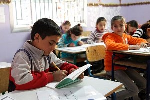 A classroom with focused children sitting at desks