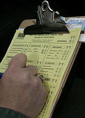 a person filling out a yellow form