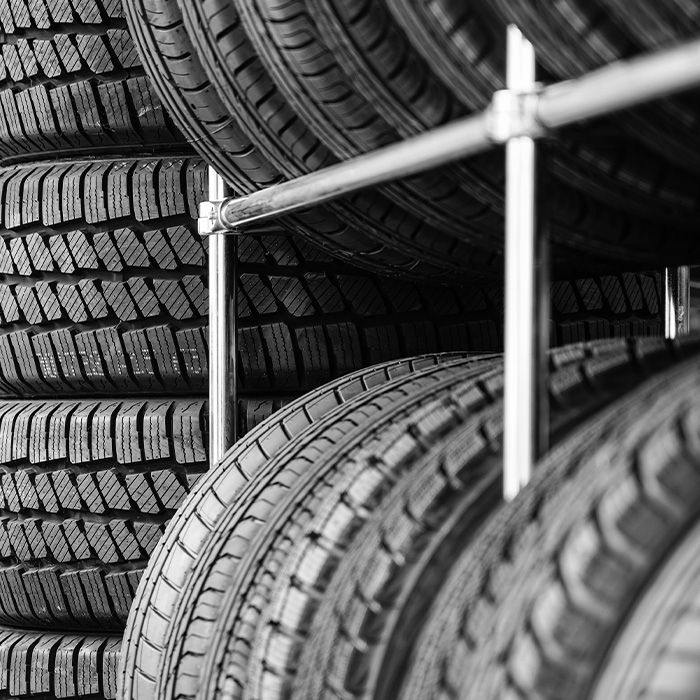 Rack with variety of new car tires in automobile store