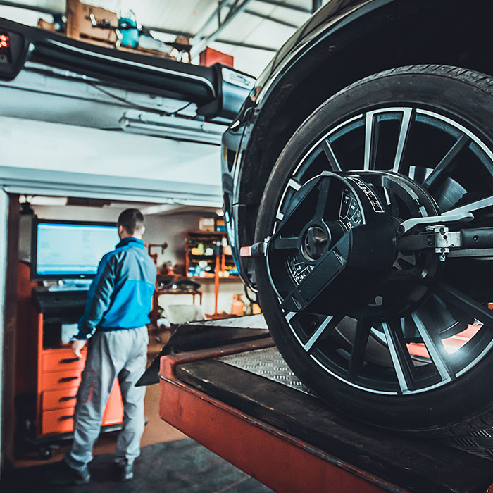 Wheel alignment equipment on a car wheel in a repair station
