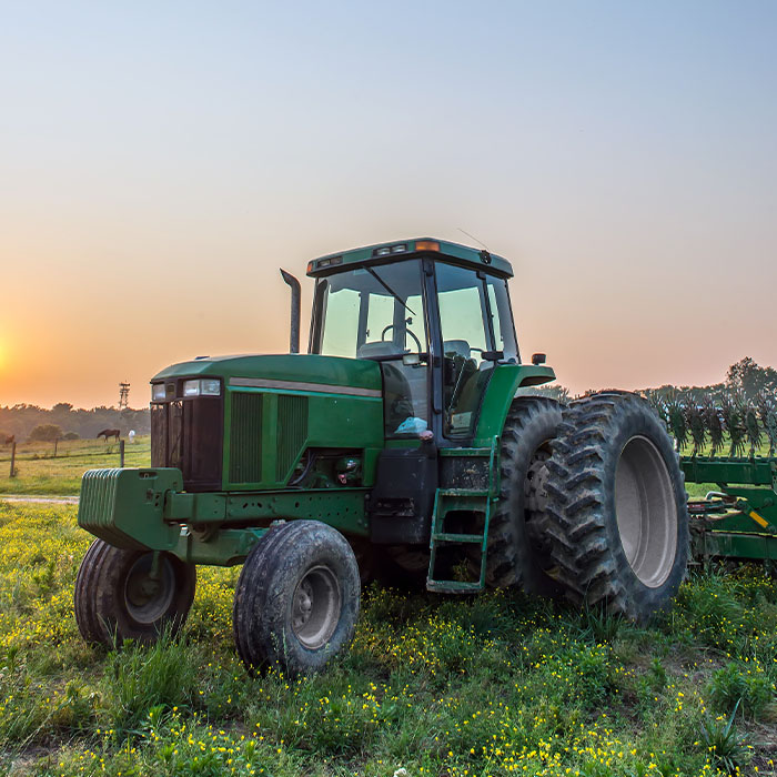 Agricultural landscape of a tractor in a field on a Maryland Farm at sunset