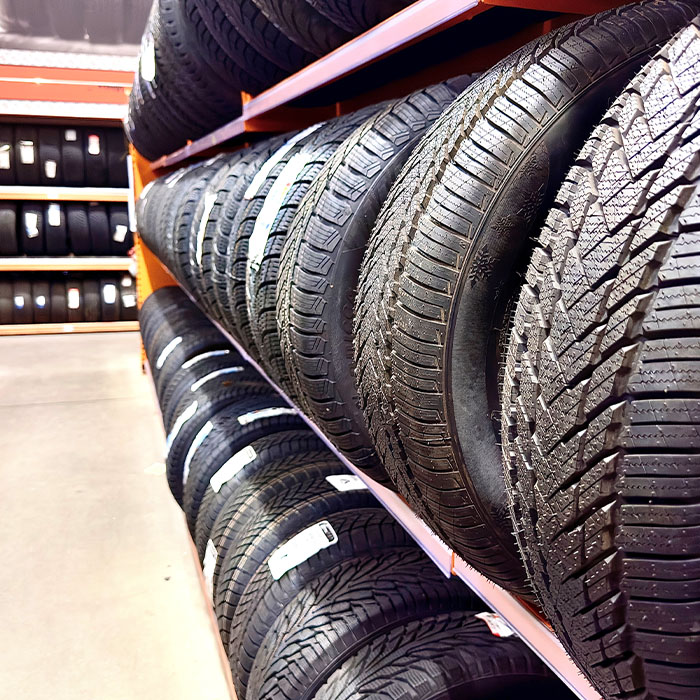 Car tires on shelf in auto shop