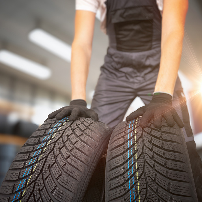 Car mechanic is changing tires