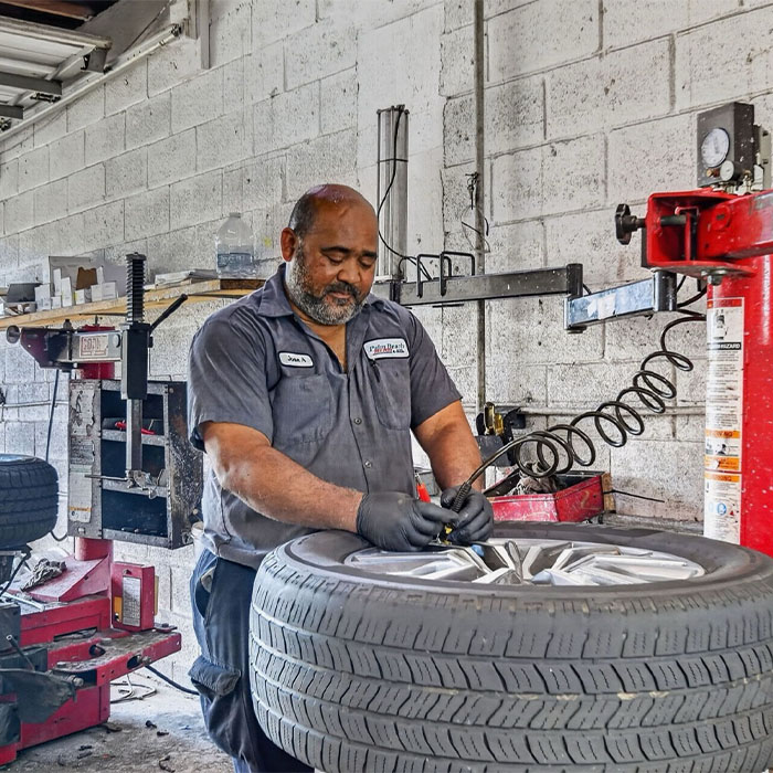 Technician fixing car tires
