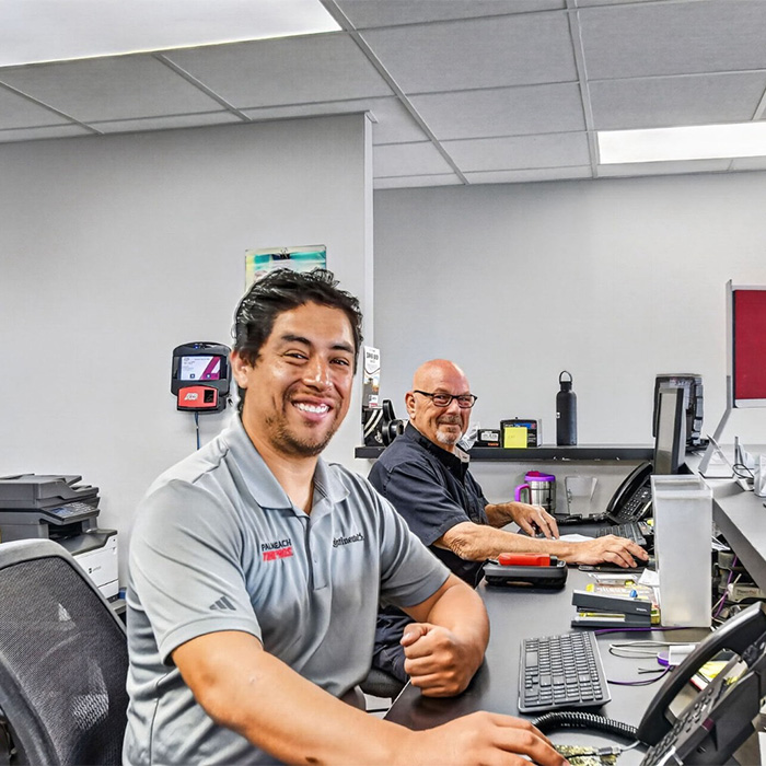 Tire Pros staff in front of computers